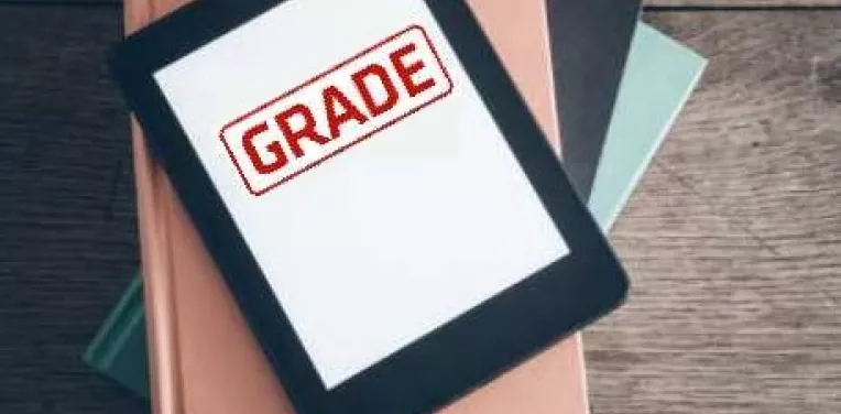 Digital tablet that says 'GRADE' on the screen